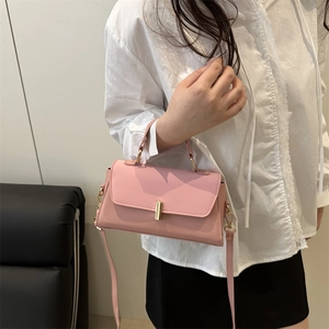 Minimalist pink leather shoulder bag with gold clasp and detachable crossbody strap for women