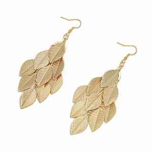 Detail of gold layered leaf drop earrings with fine textured mesh and metallic finish
