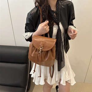 Minimalist brown PU leather backpack with drawstring and metal buckle for travel