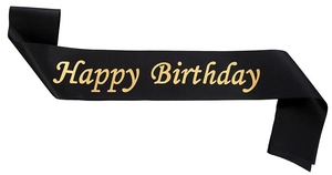 Detailed view of black satin birthday sash with elegant golden Happy Birthday lettering