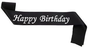 Detail of soft black satin birthday sash with elegant white Happy Birthday script