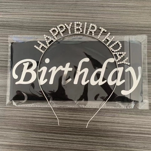 Detail of silver rhinestone Happy Birthday headband and black satin sash for party