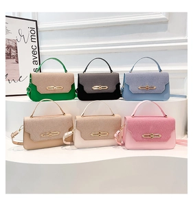 Detail of elegant patchwork crossbody bags showing textured lids and gold metal locks