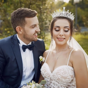 Elegant silver bridal tiara with baroque rhinestone patterns worn by a bride outdoors