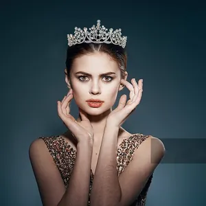 Detailed view of silver crystal tiara with intricate vine motifs worn by a model
