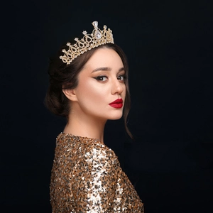 Detail of elegant gold crystal crown with water drop rhinestone on a female model