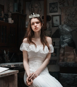 Close-up of elegant bridal crown featuring intricate teardrop crystals and silver metal