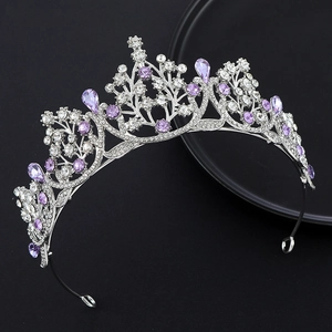 Elegant silver tiara with purple teardrop crystals and white rhinestones on black background