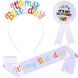 Close-up of a three-piece birthday party set with a colorful tiara, sash, and ribbon badge
