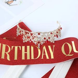 Detailed view of luxury Birthday Queen crown with red crystals and gold alloy frame