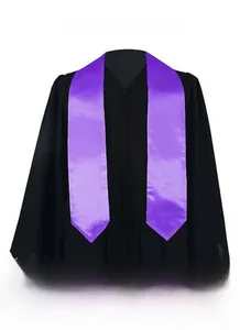 Detail of a purple satin graduation stole paired with a black matte ceremonial gown