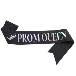 Close-up of glittery black sash with holographic Prom Queen text and crown icon