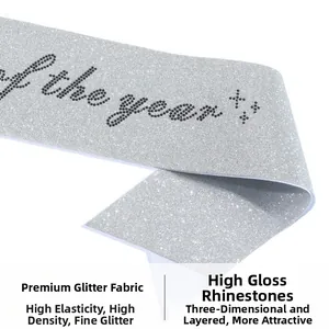 Detail of silver glitter fabric and shiny black rhinestones spelling of the year