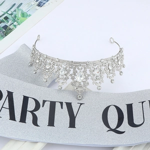 Close-up of silver crystal crown and Party Queen sash with glitter finish for women
