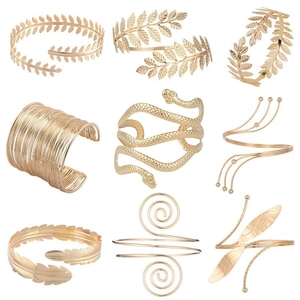 Detailed set of nine golden metal arm cuffs featuring leaf, snake, and feather designs