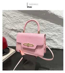 Detail of pink patchwork crossbody bag with gold twist lock and textured fabric flap
