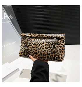 Detail of leopard print clutch bag with rectangular flap and elegant metal buckle closure