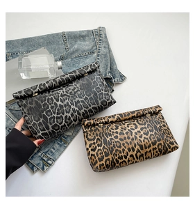 Detail of chic leopard print envelope clutches in grey and brown with gold metal accents