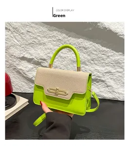Detail of neon green PU and beige fabric crossbody bag with gold buckle hardware