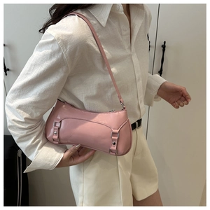 Pink patent leather shoulder bag detail with metal buckles and stylish hobo design