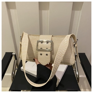 Detail of off-white crocodile pattern shoulder bag with large silver metal square buckle