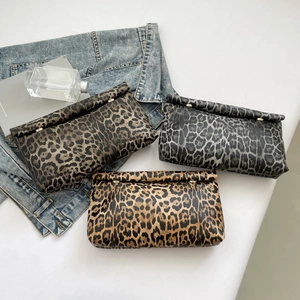 Three oversized leopard print envelope clutch bags in brown, grey, and yellow finishes