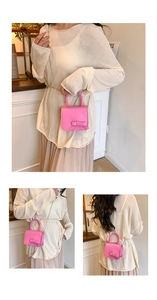 Detailed views of a small pink handbag with bow decoration and silver chain strap