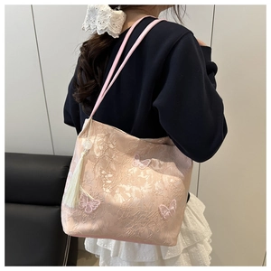Detail of pink jacquard tote bag with butterfly embroidery and white silk tassel