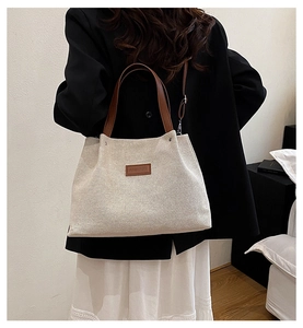 Canvas tote bag with leather straps and Fashion label shown on model's shoulder