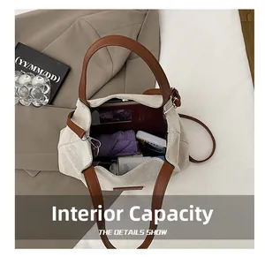 Top view of spacious interior of canvas tote bag filled with umbrella and wallet