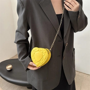 Chic yellow heart shaped crossbody bag with quilted pattern and gold chain strap
