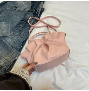 Detailed view of pink pleated cloud bag in soft PU leather with matching shoulder strap