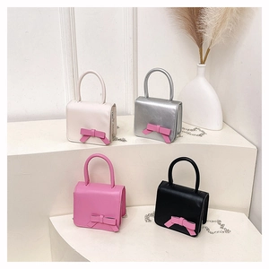 Mini handbags in four colors featuring a prominent pink bow and silver chain straps