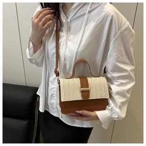 Detail of woven fabric and brown leather texture with golden buckle on crossbody bag