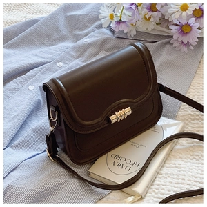 Close-up of a dark brown crossbody bag with a gold cylindrical metal lock and PU leather texture