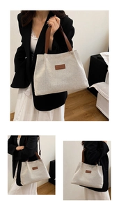 Detail showing high-capacity beige canvas tote bag with brown leather handles and fashion label