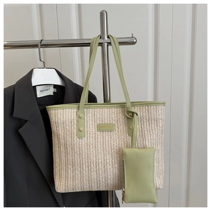 Detail of woven straw tote bag with light green trim and matching small coin purse pouch