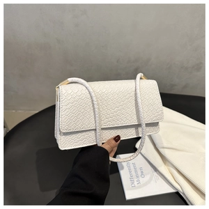 Detail showing the white crocodile pattern faux leather and golden metal hardware