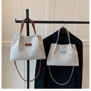 Comparison of large and small woven tote bags with leather straps and Fashion tags