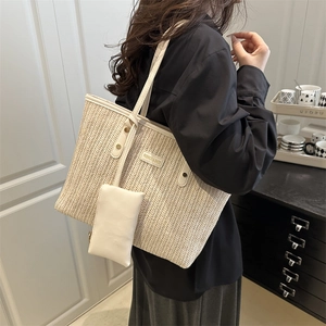 Chic cream woven tote bag for women featuring long leather straps and matching small pouch