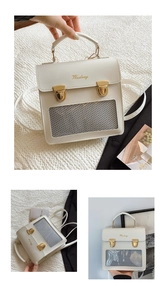 Detail view of the beige square tote bag featuring grey mesh and gold metal dual buckles
