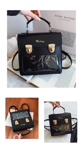 Macro detail of black PU leather backpack with transparent PVC window and gold buckles