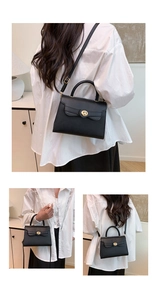 Detail of black leather handbag with gold twist lock and versatile adjustable shoulder strap