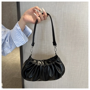 Détail du sac à bandoulière plissé noir avec finition brillante et boucles en métal argenté