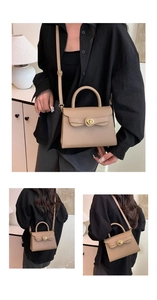 Detailed close-up of khaki leather handbag featuring a golden swivel lock and top handle