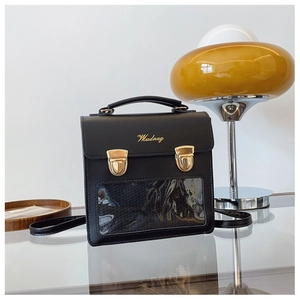 Detail of black PU leather backpack with gold buckles and clear PVC display window