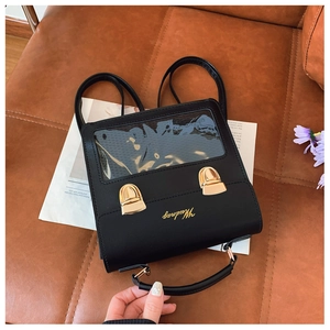 Detail of black PU leather Itabag with transparent display window and gold buckles