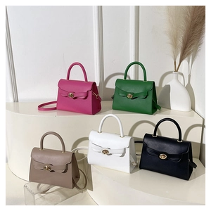 Collection of minimalist crossbody bags in five colors on white display stands