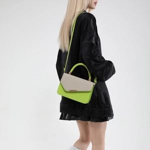 Neon green and beige woven patchwork handbag with crossbody strap and gold metal trim