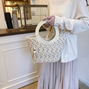 Chic woven beach tote bag with cotton rope material and beaded tassel decoration